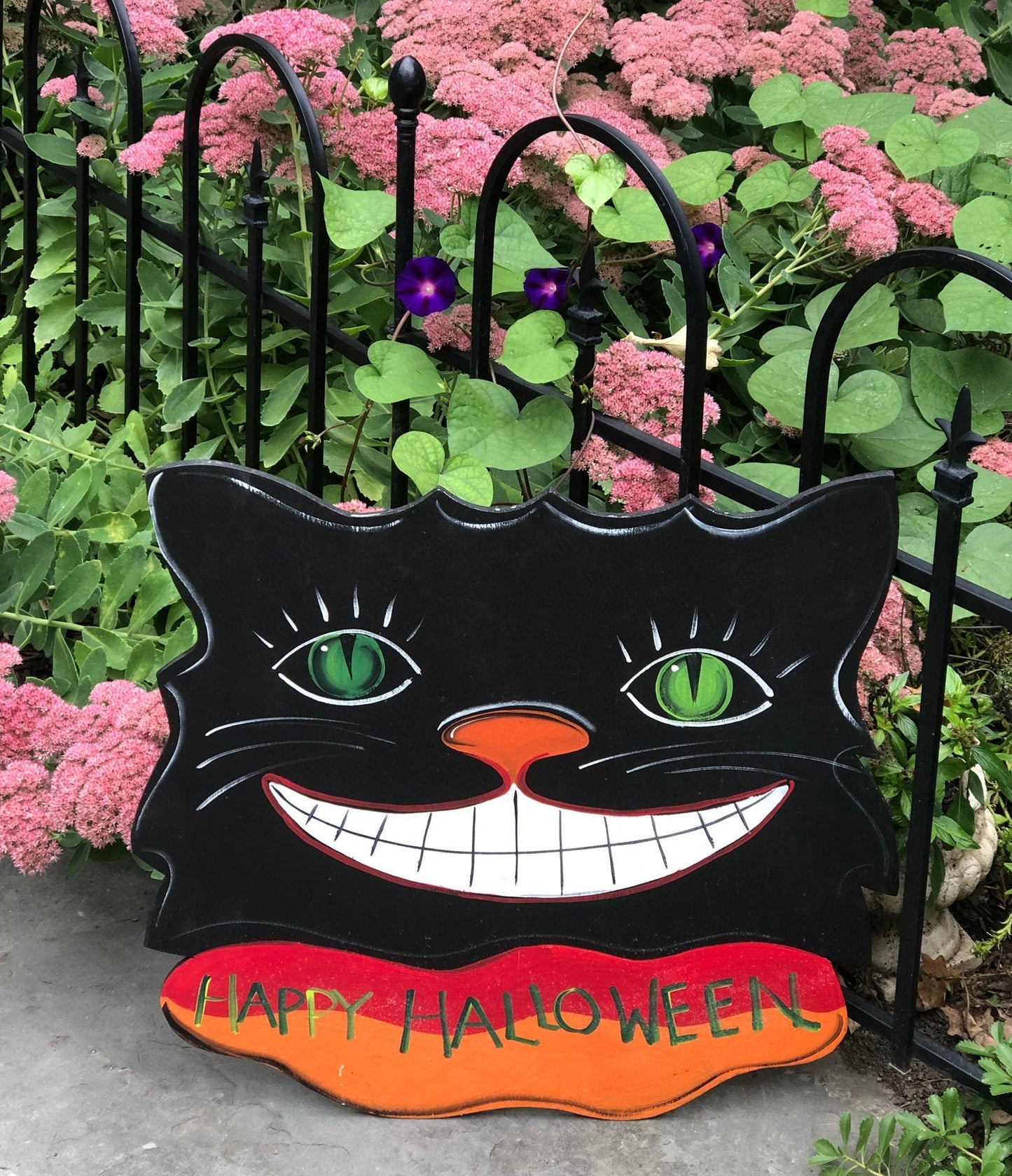 Sign on Wooden Black Cat Cutout Reading Happy Halloween.
