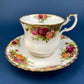 Black Cup and Saucer with Roses on White Background Inside the Cup. Royal Albert Old Country Rose Tea Set. Hand Painted Pink & Red Roses.