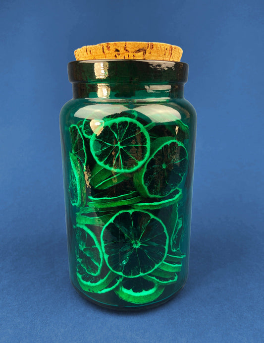 Green Glass Storage Jar with Dried  Orange Slices. Large, Deep Green Glass Canister with Cork Lid. Countertop Container.