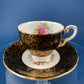 Royal Stafford Cup and Saucer. Black with Gold. Hand Painted Flower Bouquet Inside of Cup and on the Plate.