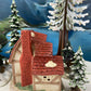 Christmas Village Farm House with Red Roof. Illuminated Building Holiday Decoration.
