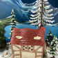 Christmas Village Farm House with Red Roof. Illuminated Building Holiday Decoration.