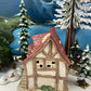 Christmas Village Farm House with Red Roof. Illuminated Building Holiday Decoration.