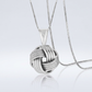Sterling Silver Pendant with a Ridge Textured Love Knot Design